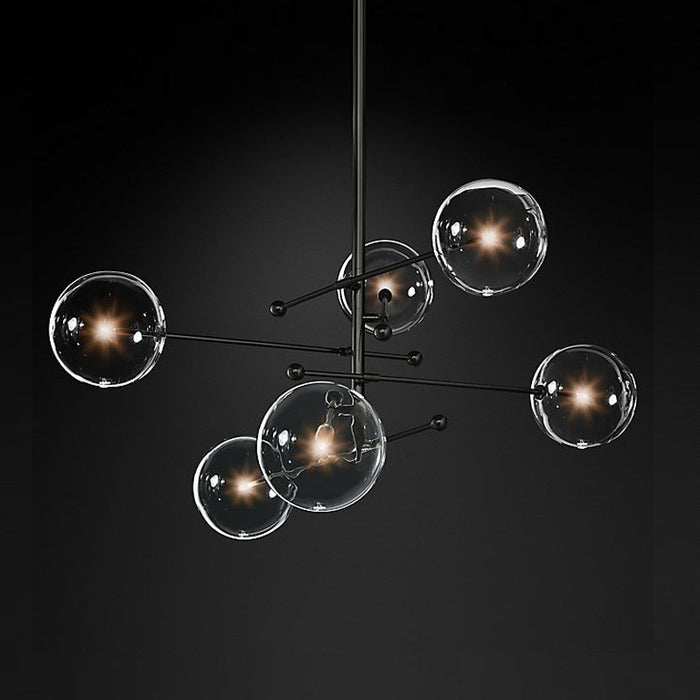 Bolla Glass Sphere Chandelier — black branch chandelier with glass sphere shades over a dining space