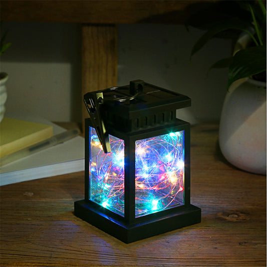 Stella Solar Star Light — solar star light glowing warmly in a night garden