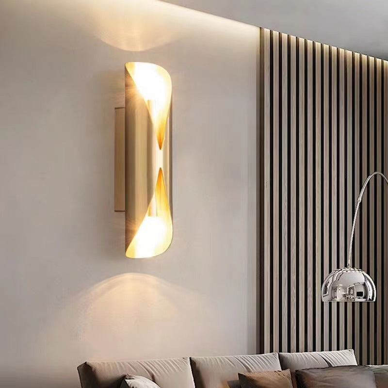 Doré Linear Brass Wall Sconce — linear brass wall sconce washing warm light up and down a living room wall