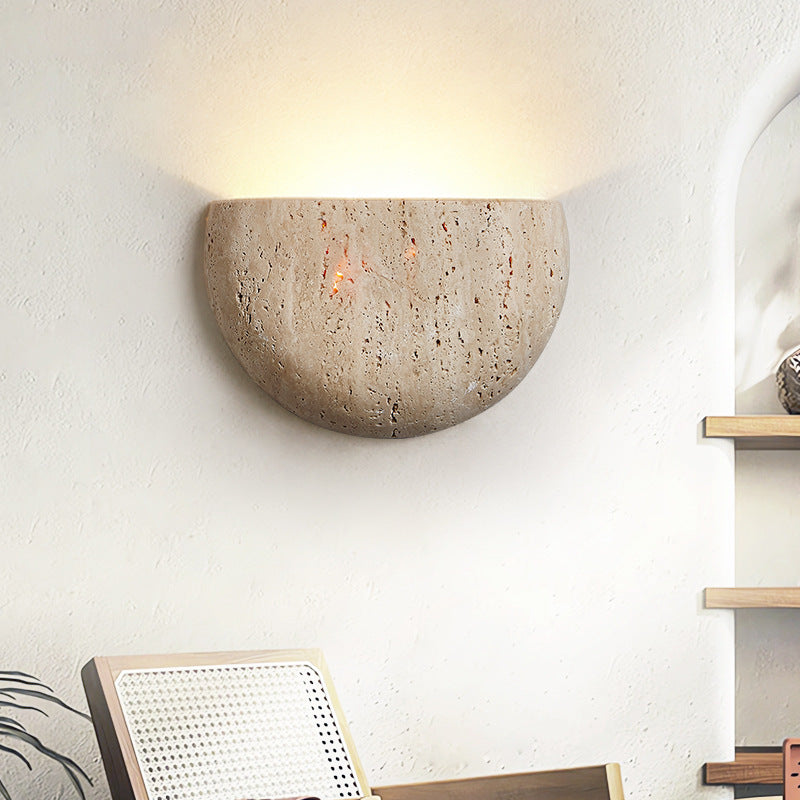 Sienna Stone Wall Sconce — stone half-dome wall sconce washing warm light up a plaster wall