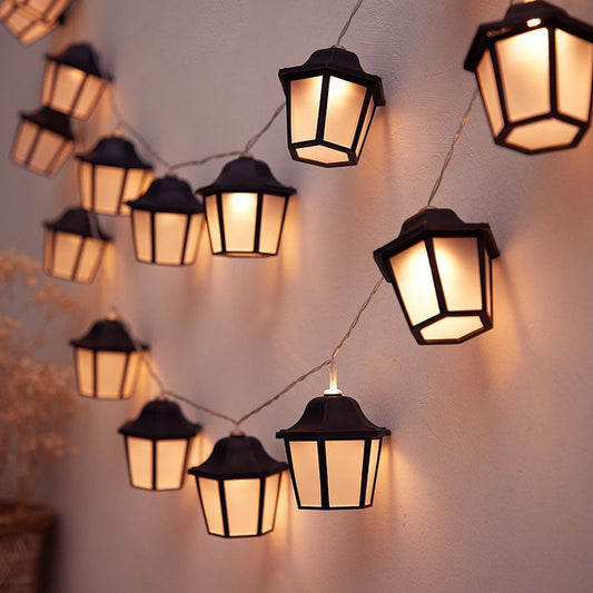 Filo Solar String Lights — warm white solar string lights draped over a terrace