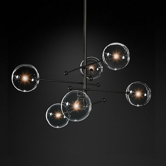 Bolla Glass Sphere Chandelier — black branch chandelier with glass sphere shades over a dining space