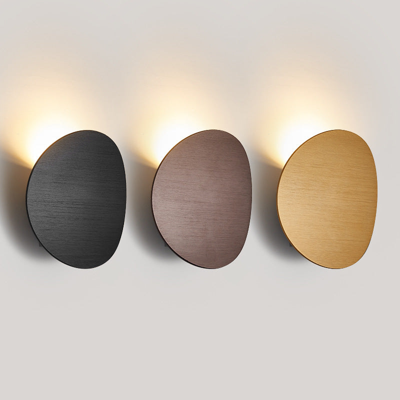Ovale Wall Sconce — round metal wall sconces glowing with warm halo backlight