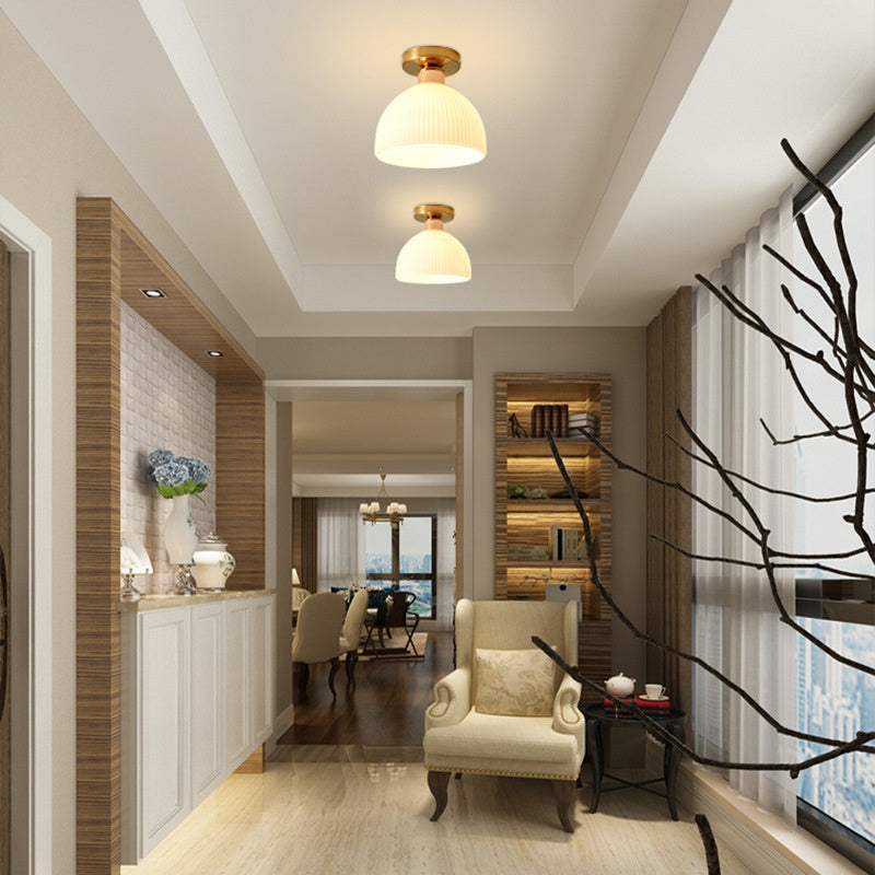 Vela Glass Globe Ceiling Light — small brass and glass globe ceiling light in a warm hallway